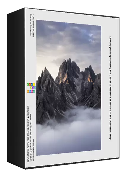 Low fog partially covering the Cadini di Misurina at sunrise in the Dolomites, Italy