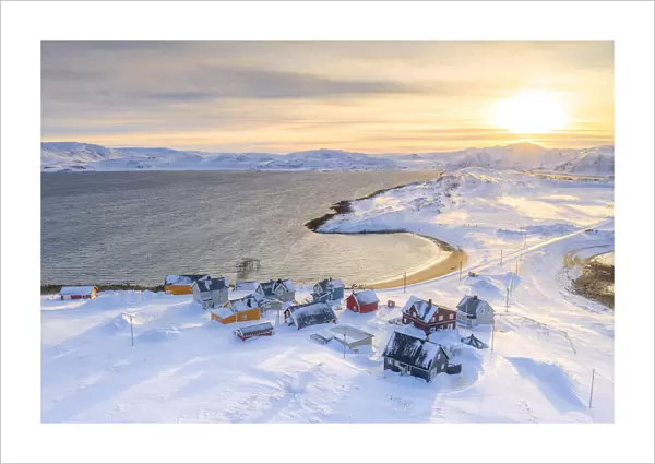 Veines village covered with snow lit by sunrise, Kongsfjord, Varanger Peninsula