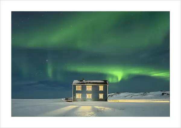 Isolated house in the snow lit by Northern Lights, Veines, Kongsfjord, Varanger Peninsula