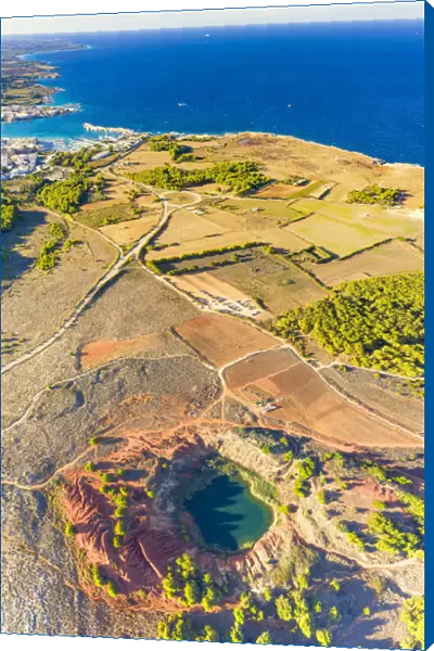 Aerial view of emerald lake and bauxite quarry with crystal clear sea on background