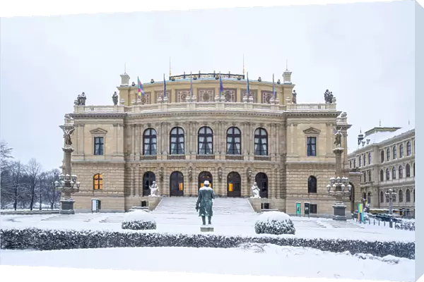 Snow-covered Antonin Dvorak statue in front of Rudolfinum concert hall in winter