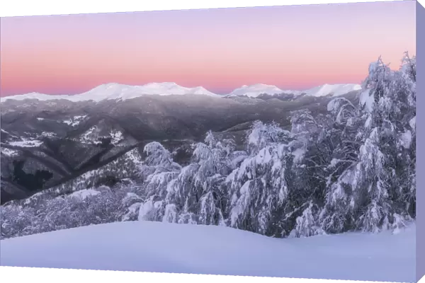 Venus belt surrounds the Appenines mountain range during a cold winter sunrise in Tuscany
