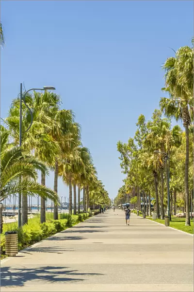 People walking along Molos promenade walkway in Limassol, Cyprus