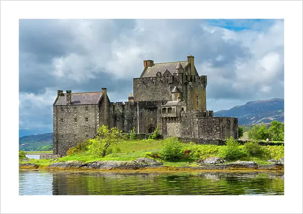 Eilean Donan Castle by Loch Duich against sky, Dornie, Kyle of Lochalsh, The Highlands, Scotland, United Kingdom