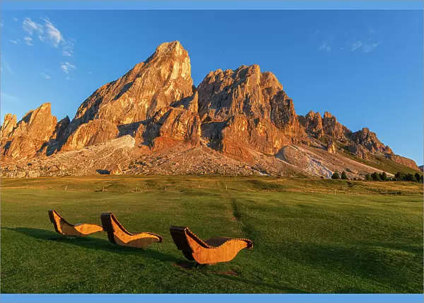 Empty wooden sun loungers for hikers in the meadows of Sass De Putia rock, Passo delle Erbe, Dolomites, Puez Odle, Bolzano district, South Tyrol, Italy, Europe