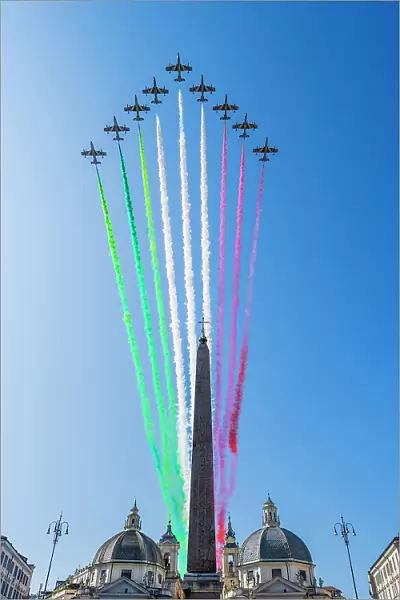 The Frecce Tricolori aerobatic team flying over Piazza del Popolo with smoke trails representing the national colours of Italy during the celebrations of Italian National Day in Rome, Lazio, Italy