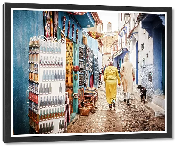 Local people walking in the street markets in the old medina of Chefchaouen, Morocco