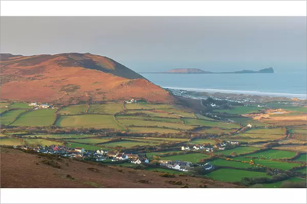 View from Llanmadoc Hill over the village of Llangennith towards Rhossili Bay and Worm's Head, Gower Peninsula, South Wales, UK. Spring (March) 2022