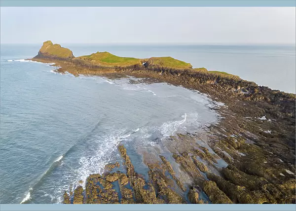 Aerial view of Worm's Head promontory on the Gower Peninsula, South Wales, UK. Spring (March) 2022
