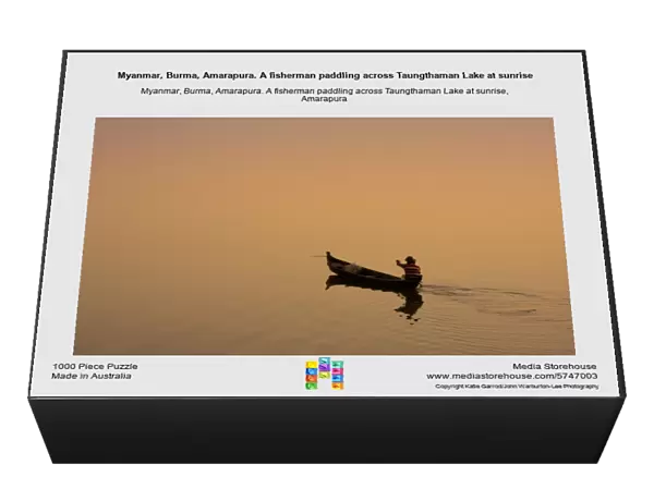 Myanmar, Burma, Amarapura. A fisherman paddling across Taungthaman Lake at sunrise