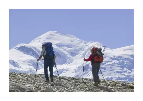 Hikers in front of Mont Blanc above Chamonix France. Like all of the alps its glaciers are melting rapidly due to global