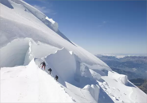 Climbers on the 4000 metre peak of Mont Blanc Du Tacul above Chamonix France