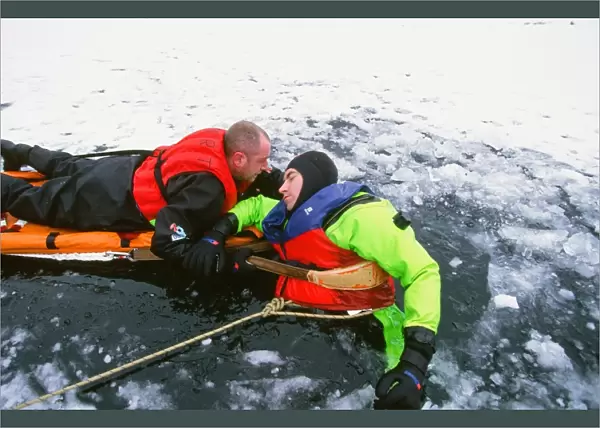 Members of the Langdale Ambleside Mountain Rescue Team rescue a man fallen through ice on Rydal Water in the Lake District