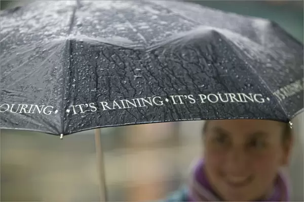 A woman using an umbrella in the rain in Ambleside UK