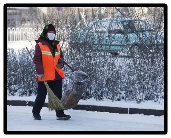 A road sweeper wears a face mask against the awful air pollution in Harbin city in Northern China. In 2008 China officially became the worlds largest single emmiter of greenhouse gases. Its woefully inadequate environmental protection measures have