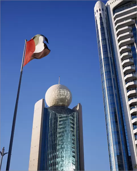 UAE, Dubai, Deira Etisalat Building on Dubai Creek with flag pole in foreground