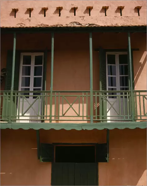 SENEGAL, Goree Island Detail of house with a green balcony, shutters and door