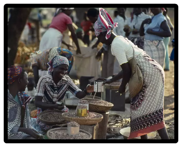20074282. MOZAMBIQUE Maxixe Street market scene with women selling beans