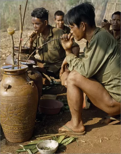 VIETNAM Vietnam War. Montagnard men drinking rice wine