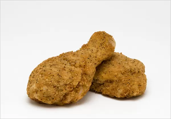 Food, Cooked, Poultry, Two breaded chicken drumsticks on a white background