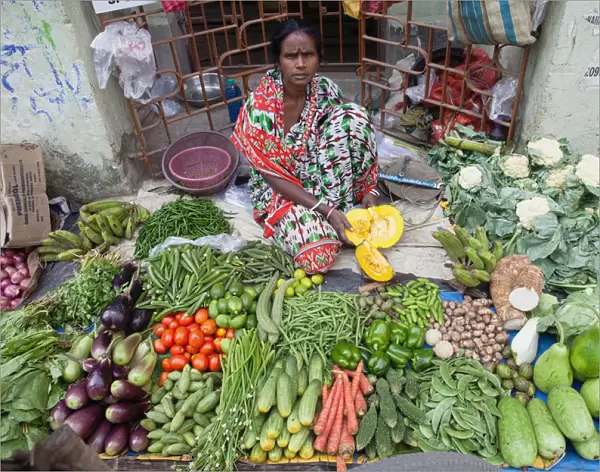 India, West Bengal, Kolkata, Vendor in the vegetable market in the Garia district