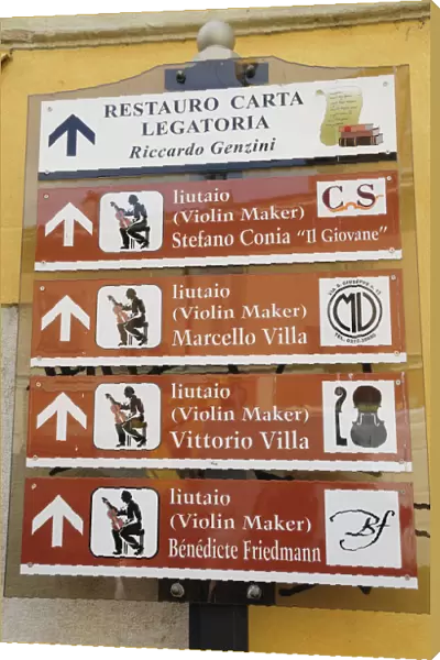Italy, Lombardy, Cremona, violin makers signs around city