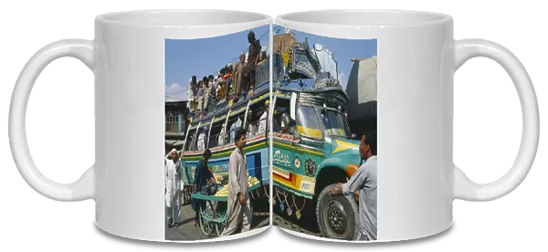 20035460. PAKISTAN Transport Crowded colourful bus in Khwakakhela Swat area. Colorful