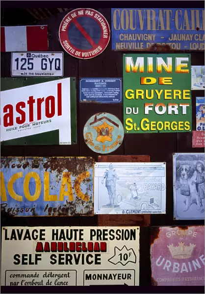 FRANCE, Indre et Loire, Chinon A collection of enamelled advertising signs seen on a