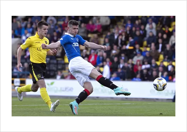Thundering Towards Glory: Fraser Aird's Determined Shot for Rangers in SPFL Championship Match against Livingston