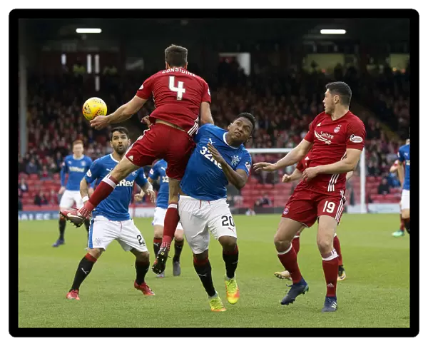 Rangers Alfredo Morelos Soars for the Ball in Intense Rangers vs Aberdeen Clash at Pittodrie Stadium