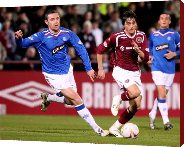 David Weir and Deividas Cesnauskis in Action: Rangers 4-0 Triumph over Heart of Midlothian at Tynecastle Stadium (Clydesdale Bank Premier League)