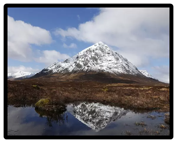 The mountain Buachaille Etive Mor is reflected in water near Ballachulish, Scotland