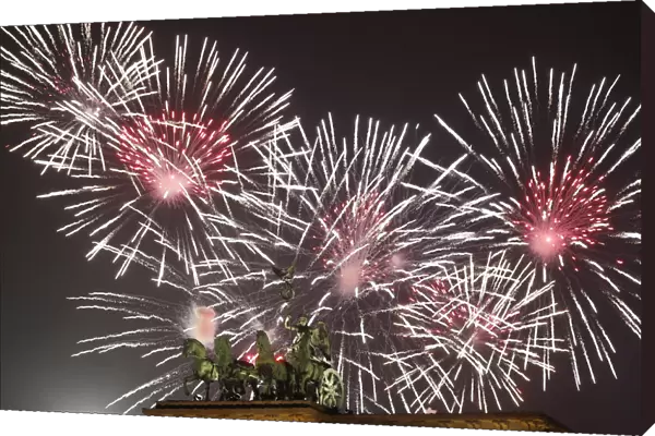 Fireworks explode next to the Quadriga sculpture atop the Brandenburg gate during