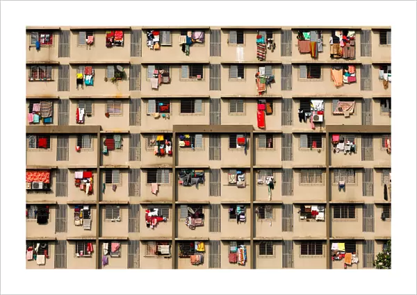 Laundry is seen hanging on the windows of a residential building in Mumbai