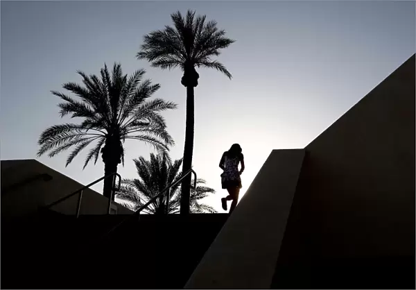 A tennis fan walks up the gangway leading into the main stadium at the Indian Wells