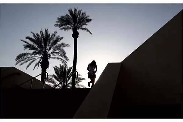 A tennis fan walks up the gangway leading into the main stadium at the Indian Wells