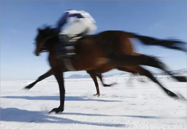 Riders compete on frozen Yenisei River during 47th Ice Derby amateur horse race near