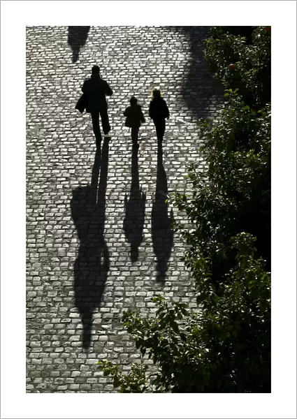 A man and children walk on the street in the Andalusian capital of Seville, southern