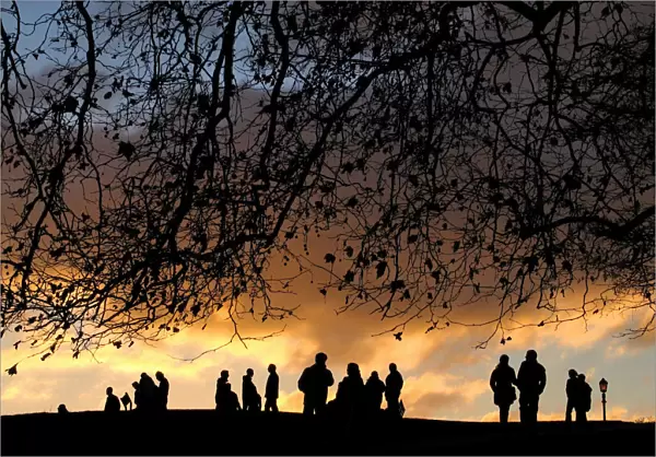 LONDONERS WATCH SUNSET OVER CITY FROM PRIMROSE HILL