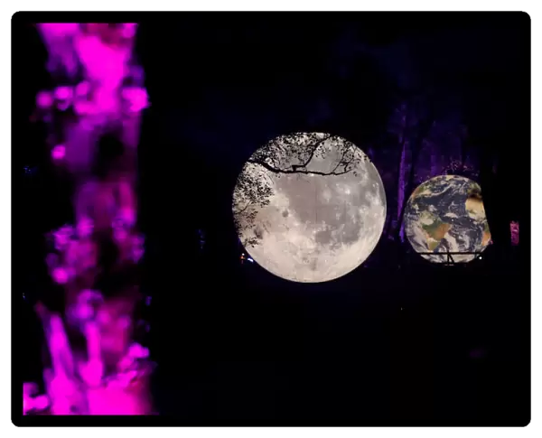 An earth and moon installation are reflected at the Enchanted Forest 2019 event Cosmos
