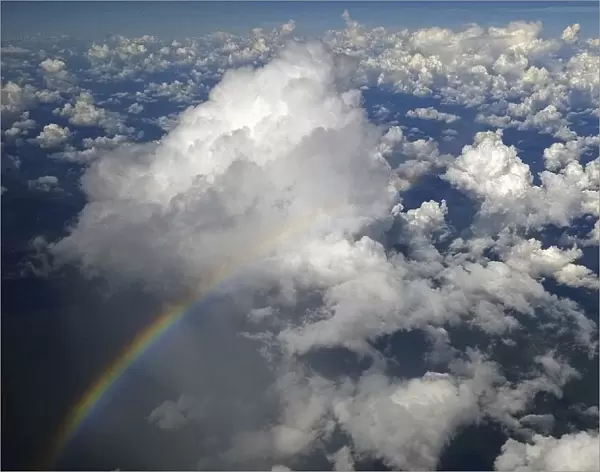 A rainbow appears as fluffy clouds are seen over the Amazon in Brazil during the 2014