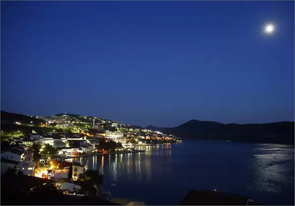 The moon is reflected in the sea in the town of Neum