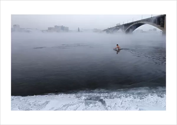 Vladimir Shcherba, a fan of winter swimming, dips to the Yenisei River at air temperature