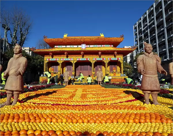 Workers put the final touches to a replica of the Forbidden City made with lemons