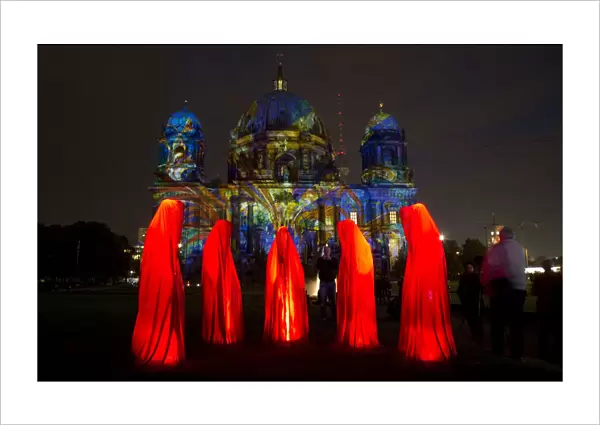 People look at a light installation during the opening day of the Festival of Light