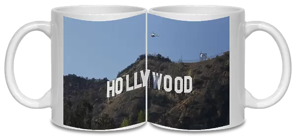 A LAPD helicopter flies over the Hollywood sign in Hollywood