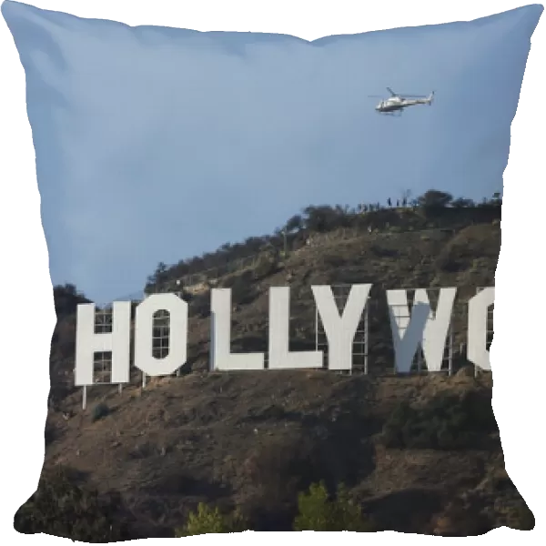 A LAPD helicopter flies over the Hollywood sign in Hollywood