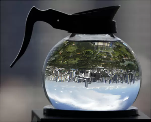 A coffee pot filled with water acts as a lens to depict Lumpini Park in Bangkok