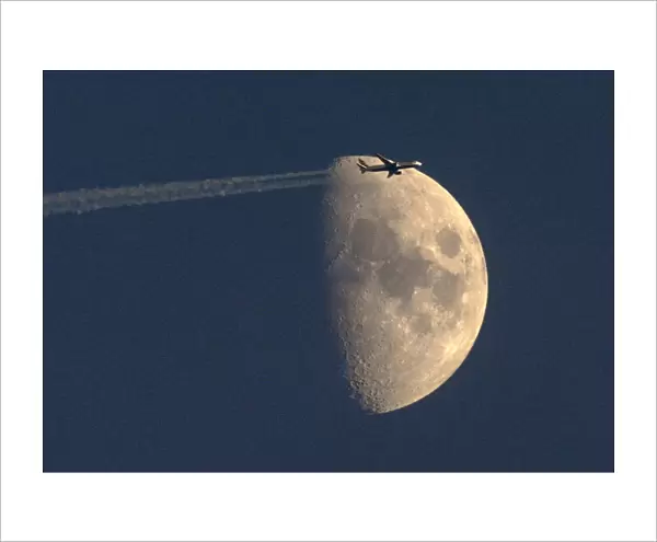A British Airways passenger jet flies past the waxing moon over Zurich