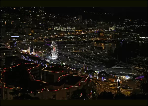 Christmas decorations and a Ferris wheel light the port of Monaco during holiday season